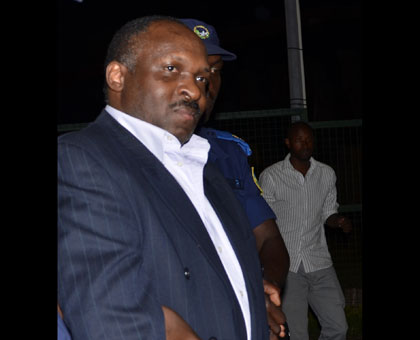 Mbarushimana is taken into custody by Rwandan National Police after his exchange at Kigali International Airport on July 3. File.