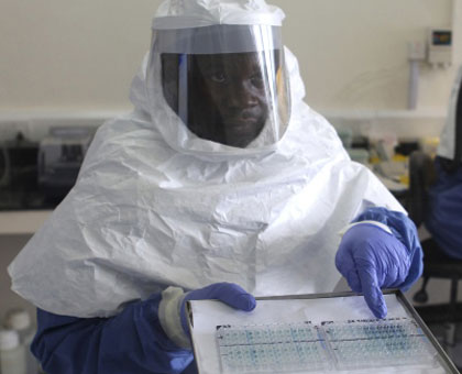 A Ugandan doctor shows test results for Ebola samples in a past outbreak. Net photo.