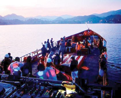 Party goers enjoy the view of sunrise aboard the barge during last years event. (Judith Kaine)