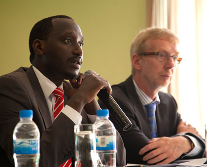 Nkusi (L) with Tillessen during the review meeting in Kigali yesterday. (Timothy Kisambira)