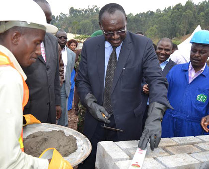 Minister Kanimba lays a foundation stone at the site where the market will be constructed. (Jean du2019Amour Mbonyinshuti)