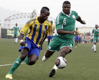 Amavubi defender Mbuyu Twite beats Nigeria striker Yakubu Aiyegbeni to the ball during a previous meeting between the two teams in 2012 in Kigali. (File photo)