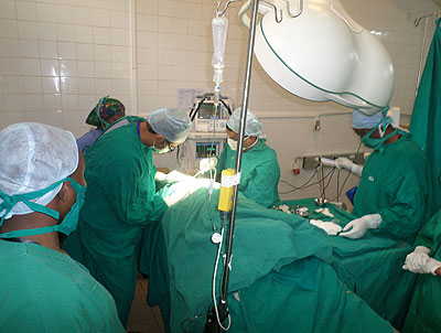 Rotary Medical Mission members carry out urologic surgery on a patient at Chuk.  Ivan Ngoboka.   