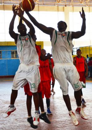 Bienvenu Ngandu of Espoir, right, goes up for a defensive rebound against CSK in Game 1 yesterday at Amahoro indoor stadium. Sam Ngendahimana