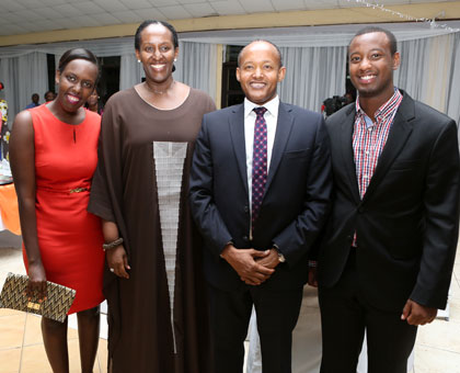 The First Lady and Faustin Mbundu, the Chairman of Greenhills Board, pose for a photo with two former students of Greenhills Academy during the dinner on Thursday. (Village Urugwiro)