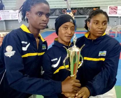 Solange and team mates Rehema Kabera and Providence Mutuyimana show off the teamu2019s Best Performance trophy. (Courtesy)