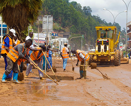 Workers clear Nyabugogo road of mud after floods last year.  The spot of bother has since been fixed.  Timothy Kisambira.