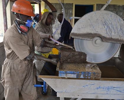 Some members of the Kohia cooperative make tiles from volcanic rocks. Jean du2019Amour Mbonyinshuti.