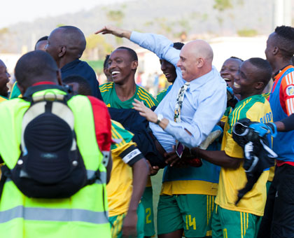 Constantine was carried aloft by his players after Rwanda beat Congo to qualify for the group stage of Afcon-Morocco 2015 finals. (Timothy Kisambira)