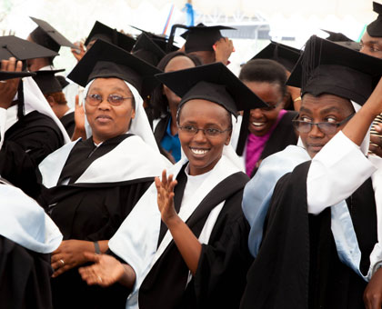Graduates share a light moment after graduation yesterday. (Timothy Kisambira)