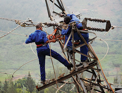 EWSA workers fix a powerline. The government is promoting infrastructure development to spur economic growth. File.