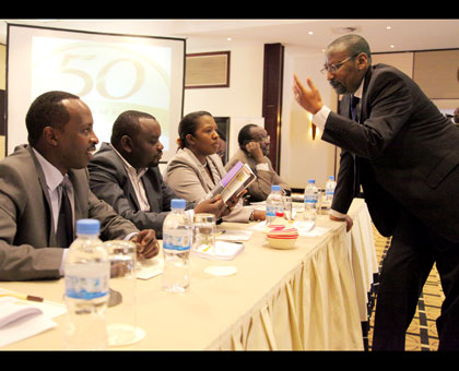Central bank governor John Rwangombwa chats with Southern Province governor Alphonse Munyantwali (L). Also present were City of Kigali vice mayor for finance and economic development Alphonse Nizeyimana (2nd L), Eastern Province governor Odette Uwamariya, and Trade and Industry minister Francois Kanimba. John Mbanda.