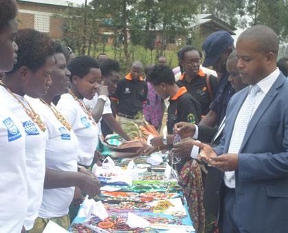 The Director General of WDA, Jerome Gasana, with other officials visit the art and craft stand at the exhibition during the certificate awarding ceremony. (Grace Mugoya)