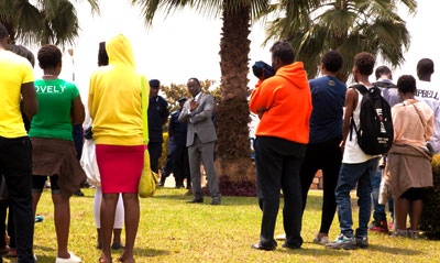 Kigali City mayor Fidu00e9le Ndayisaba (centre, background) speaks to teenagers who were rounded up from several bars during a recent night-long Police swoop. File. 