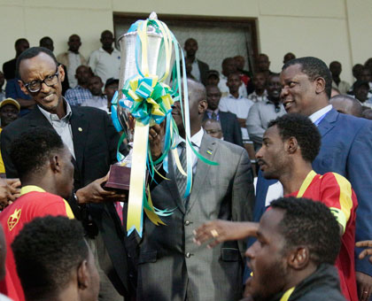 President Paul Kagame, the Patron of Cecafa Kagame Cup championships, hands over the 2014 editionu2019s trophy to El Meriekh at Amahoro stadium last evening. (Village Urugwiro)