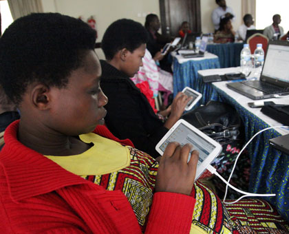 Women browse the internet during a training workshop in Kigali recently. File. 