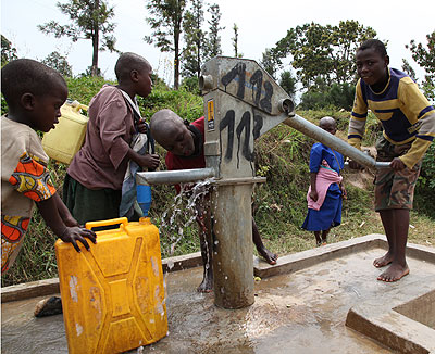 Children fetch water at a public borehole. Over 11% of city dwellers donu2019t have access to safe water. File.