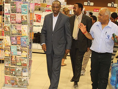 Amb. Sezibera (left) and Arusha mayor Gaudence Lyimo on a guided tour of Nakumattu2019s 50th store in Arusha by Shah (right). Courtesy. 