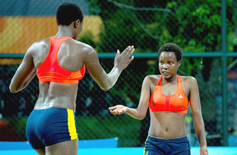 Seraphine Mukantambara, left , and Lea Uwimbabazi celebrate winning a set during their victory over Argentina. (Courtesy)