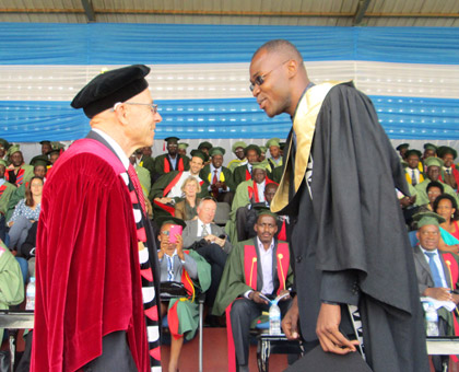 Ambroise Jean-Louis gets the confidence vote of Dr Ou2019Neal, during the University of Rwandau2019s maiden graduation last week. (Timothy Kisambira)