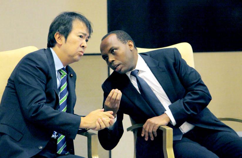 RDB chief executive Francis Gatare (R) chats with Japanese parliamentary vice minister for Foreign Affairs Hirotaka Ishihara during a consultative meeting on investments in Kigali yesterday. (John Mbanda)