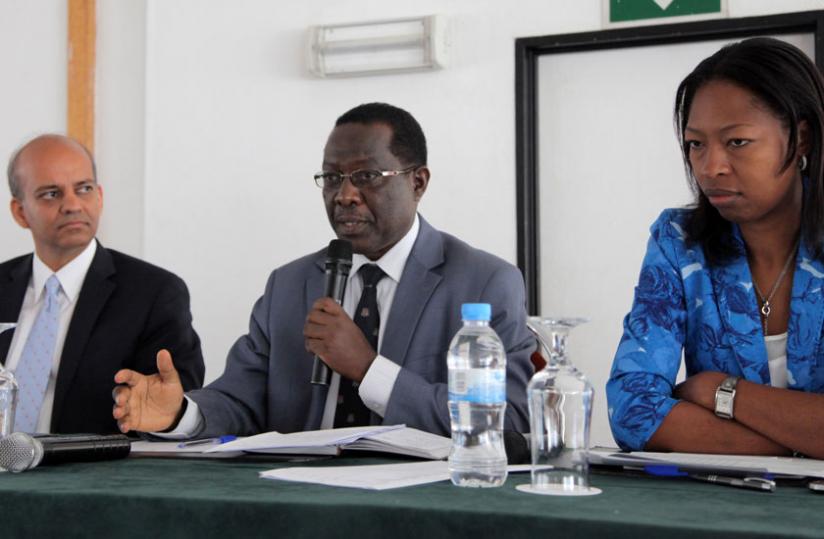 Geology and Mines chief Biryabarema (C) addresses participants during the meeting on mining in Kigali yesterday. Looking on are Apurva Sanghi of World Bank (L) and Amina Rwankunda of the Ministry of Finance and Economic Planning. (John Mbanda)