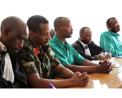 Col. Tom Byabagamba,Rtd Sergeant Francois Kabayiza (centre) and Rtd Brig Gen. Frank Rusagara with their lawyers in court yesterday. (John Mbanda)