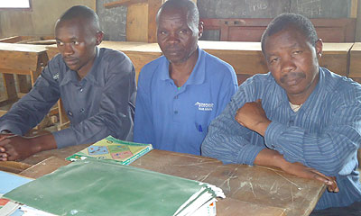 Ayindigira (right), the school head teacher with two of his teachers. 
