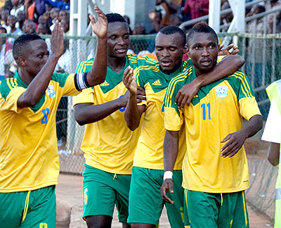 Birori, right (#11), celebrates with team mates after completing his hat trick against Libya in the first round of Afcon 2015 qualifiers in May 2014. (T. Kisambira)