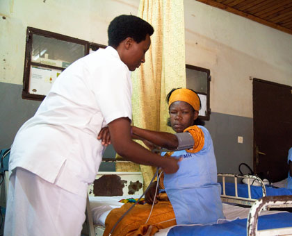 A nurse attends to a pateint at Rwanda Military Hospital, Kanombe. (Timothy Kisambira)