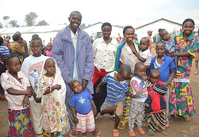  Singirankabo poses for a photo with his two wives and children repatriated last year. (Jean Pierre Bucyensenge)