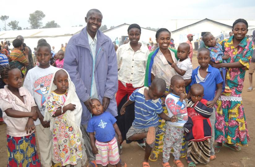 Singirankabo poses for a photo with his two wives and children repatriated last year. (Jean Pierre Bucyensenge)