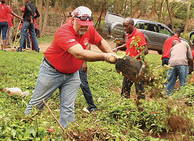 Bhullar (foreground) and other Airtel workers join Kagara village residents during last monthu2019s Umuganda. (Courtesy)