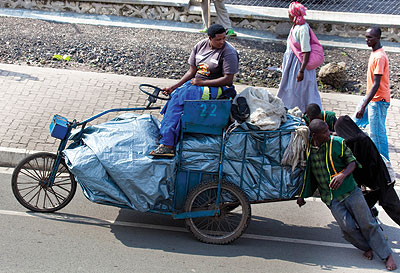 A business woman is helped to transport her mrachandise to Goma market across the DRC/Rwanda border. 