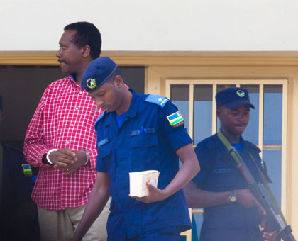Kabuye is escorted out of the court on Monday. Timothy Kisambira.