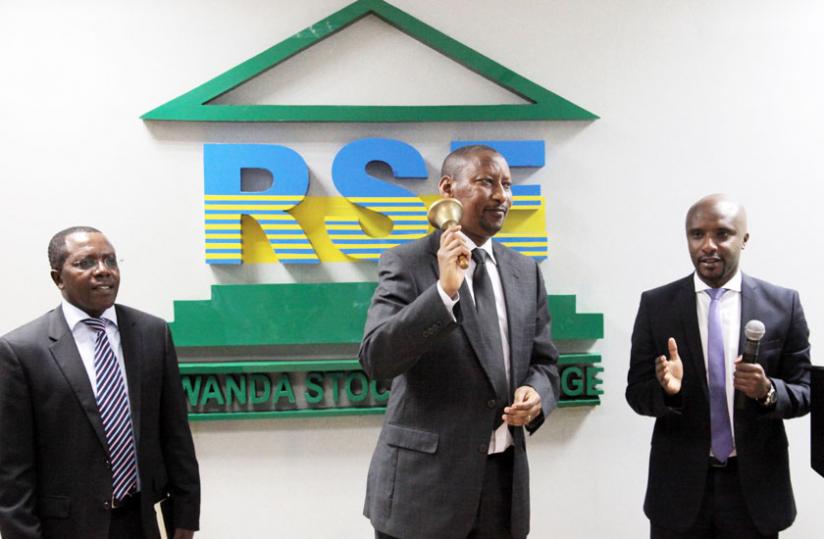 Central bank governor John Rwagombwa (C) rings the bell to launch of the trading of the bonds yesterday as executive director CMA Robert Mathu (L) and RSE chief executive Celestin Rwabukumba look on. (John Mbanda)