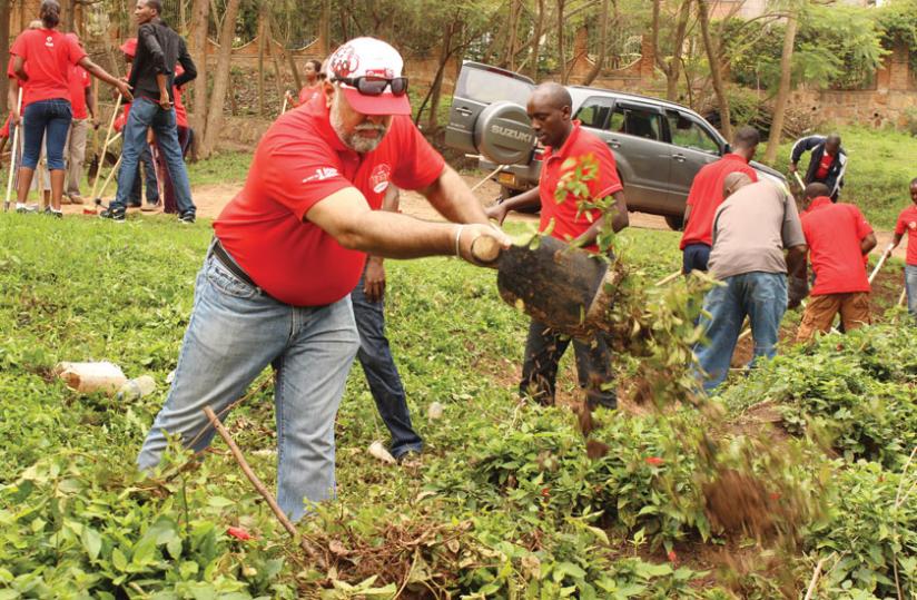 Bhullar (foreground) and other Airtel workers join Kagara village residents during last monthu00e2u20acu2122s Umuganda. (Courtesy)