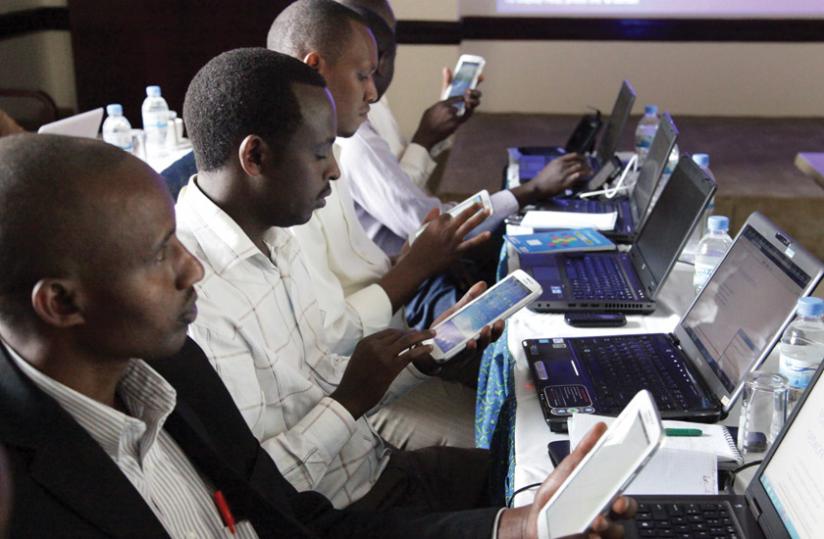 Teachers use tablets to surf the Internet at a recent workshop. Internet penetration is still low in Rwanda.  (John Mbanda)
