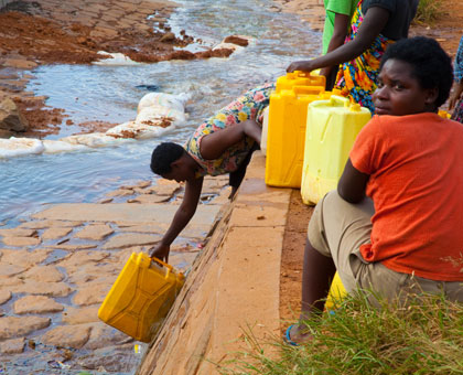 People draw water in Kimisagara, a Kigali city suburb.  Recent research shows that about  480 million people in Africa will face water scarcity by 2025. File.