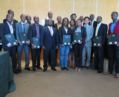 Minister Nsengimana poses for a group photo with beneficiaries of the scholarship programme yesterday.  Emmanuel Ntirenganya. 