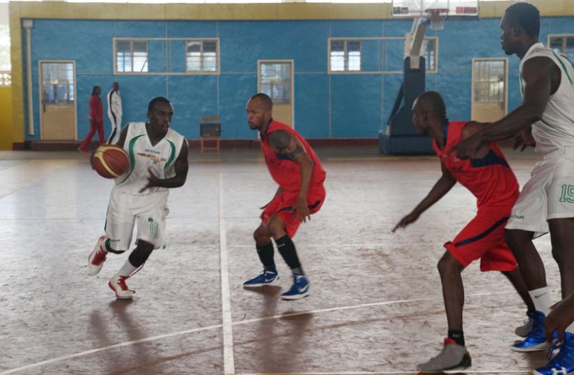 Espoiru00e2u20acu2122s Aristide Mugabe, left, dribbles past CSKu00e2u20acu2122s Patrick Buzangu during Game Four of the playoffs final played yesterday at Amahoro indoor stadium. (R. Bishumba)