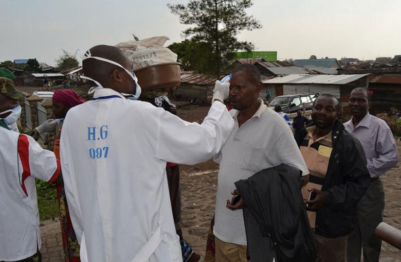 A Rwandan medical official screens travellers crossing from DR Congo through the Petite Barriere border post last week. (Jean du00e2u20acu2122Amour Mbonyinshuti)