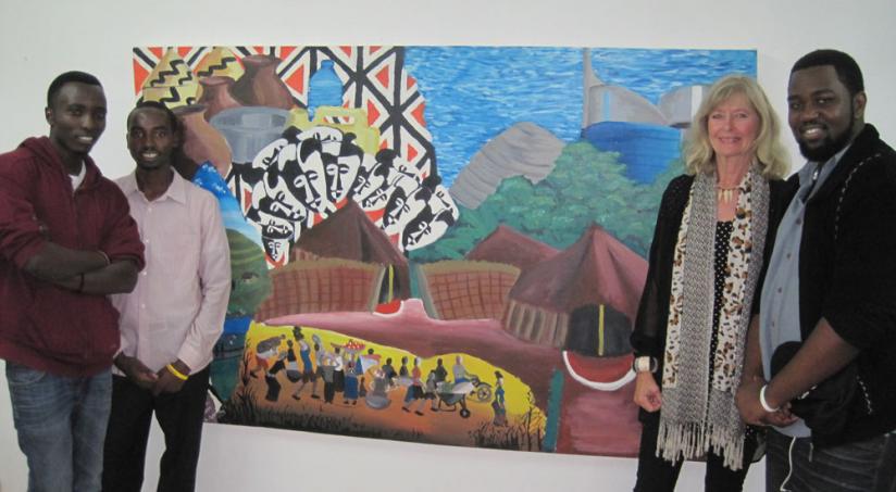 Anne Holmes, 2nd right, poses with the art students next to the main picture of the exhibition. (Courtesy photo)