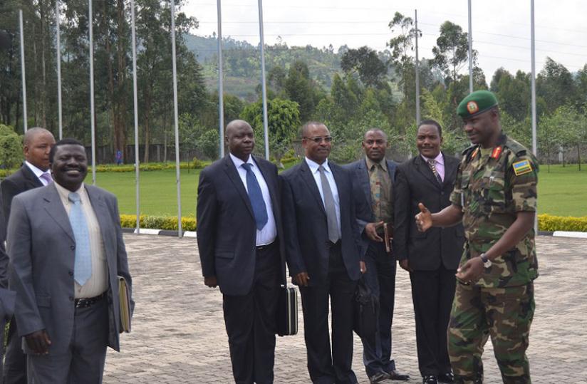Brig. Gen. Charles Karamba, commandant RDF Command and Staff College, (right) shares a light moment with his colleagues at Musanze yesterday. (Jean du00e2u20acu2122Amour Mbonyinshuti)