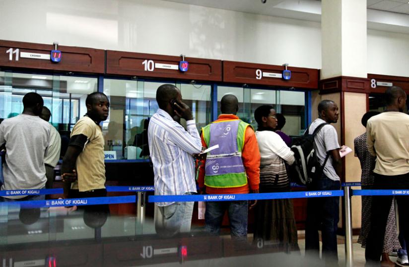 Clients at a Bank of Kigali branch queue to get served. (File)