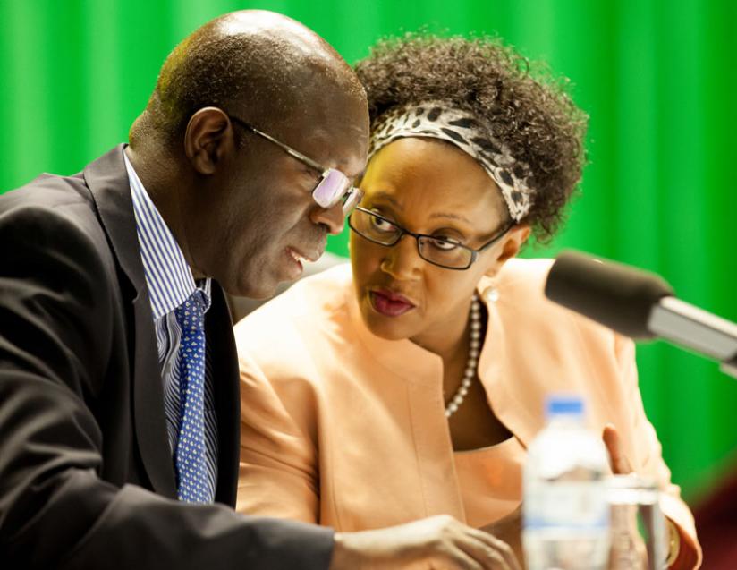 Prime Minister Anastase Murekezi chats with Stella Ford Mugabo, the minister for Cabinet affairs, during the Imihigo validation meeting at the Office of the Prime Minister yesterday. (Timothy Kisambira)