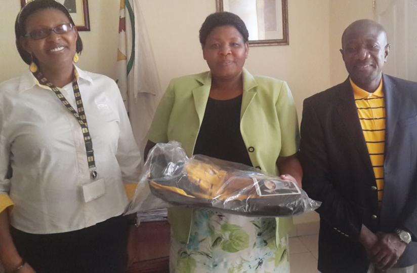 Mukasonga (middle) with MTN managers at her office yesterday. (Ben Gasore)