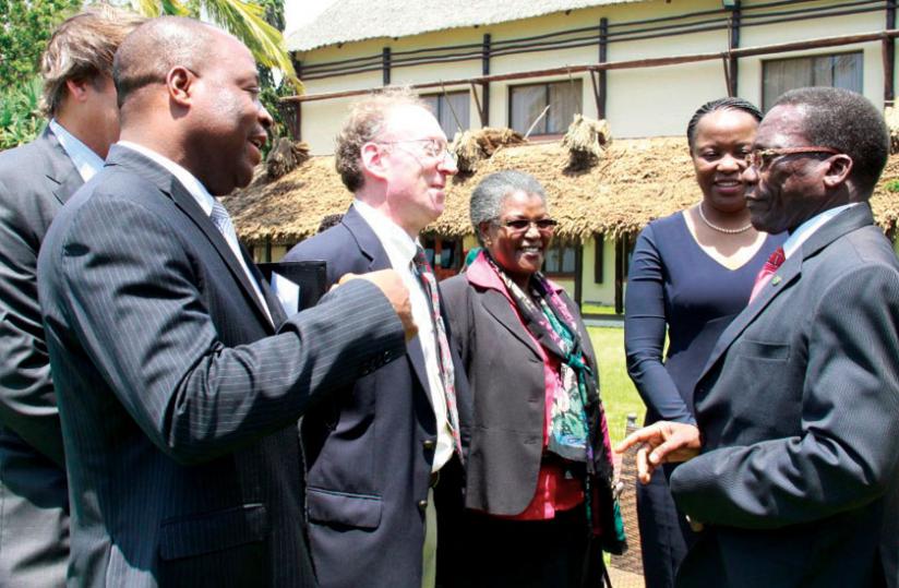 PM Mizengo Pinda (right) talks to DLA Piper trainers after opening the seminar at the White Sands Beach Resort in Dar es Salaam. Looking on is EADBu00e2u20acu2122s Yeda (second right) and EADB board member Hadija Simba (third right). (Courtesy)