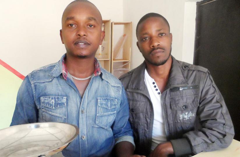 Muhoza (left) with his business partner Theo Mungaliho at their office in Kacyiru. Moses Opobo.