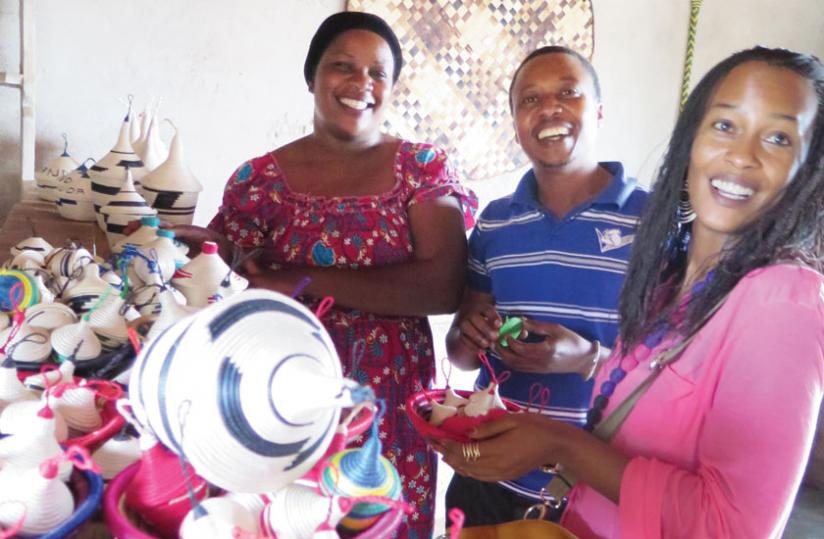 Kado (left) and Kaitesi admire some of the groupu00e2u20acu2122s artifacts. Kado keeps all the groupu00e2u20acu2122s products free of charge. (Stephen Nuwagira)